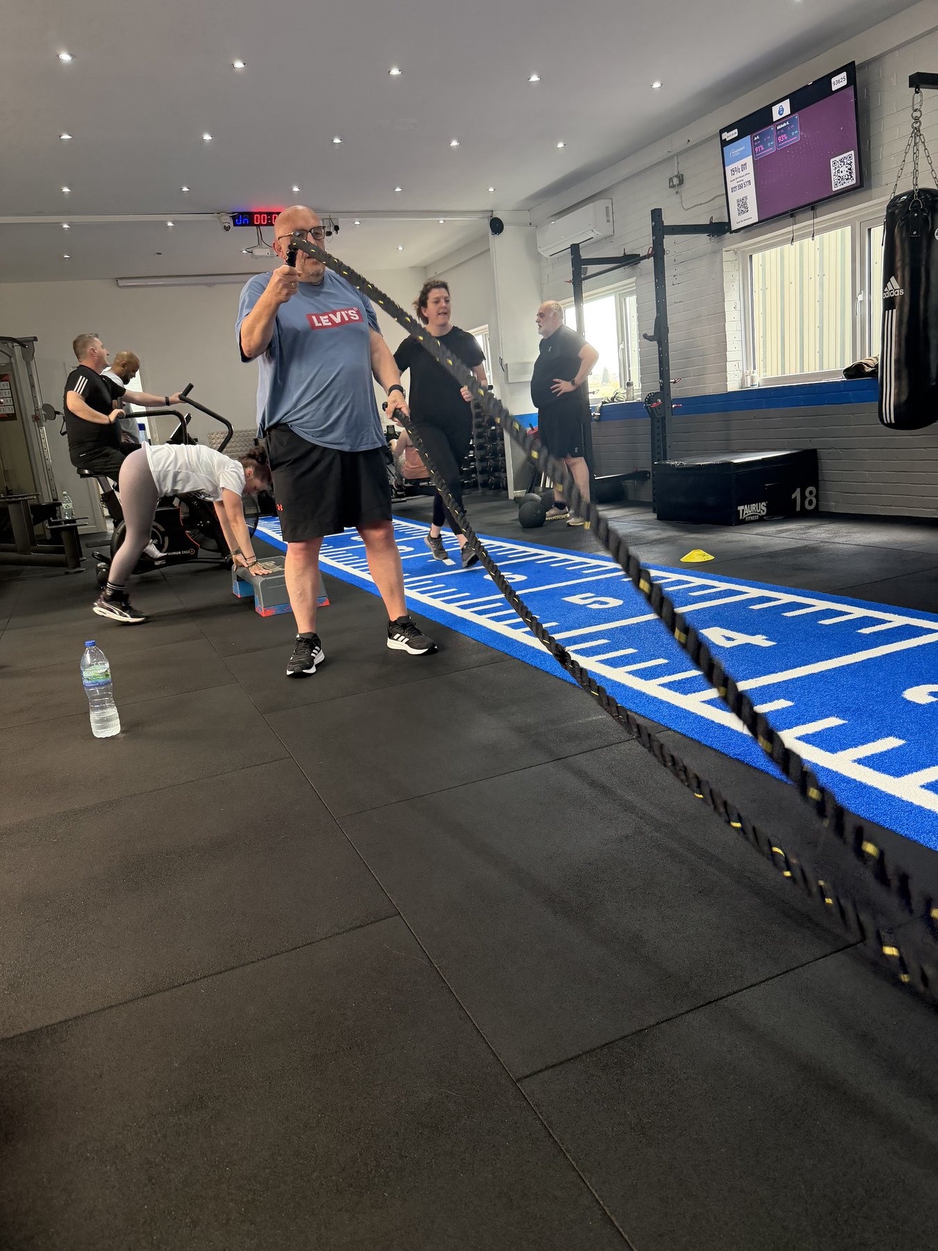Member using battle ropes at SPS Fitness Halesowen during a small group training session